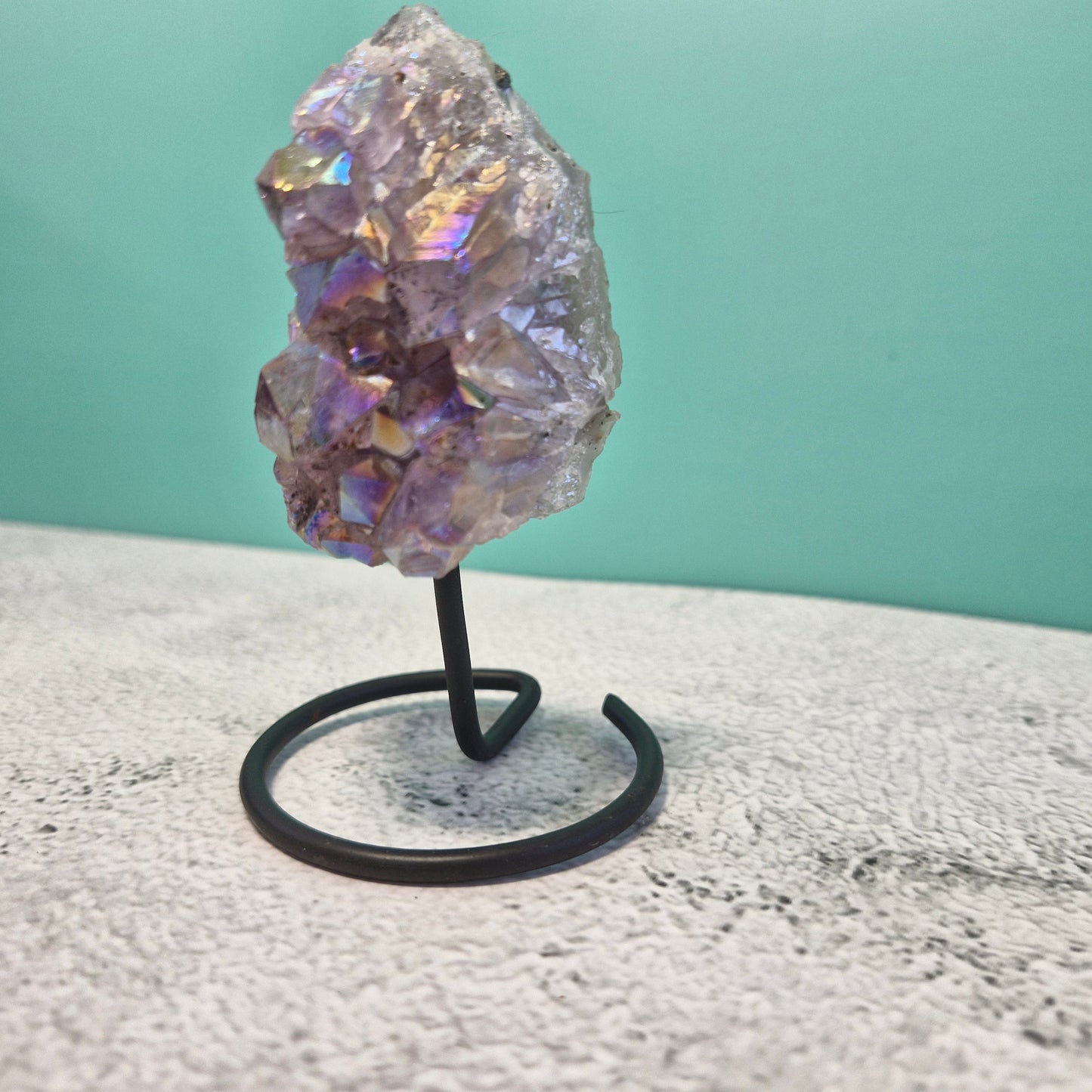 Small aura amethyst geode on stand