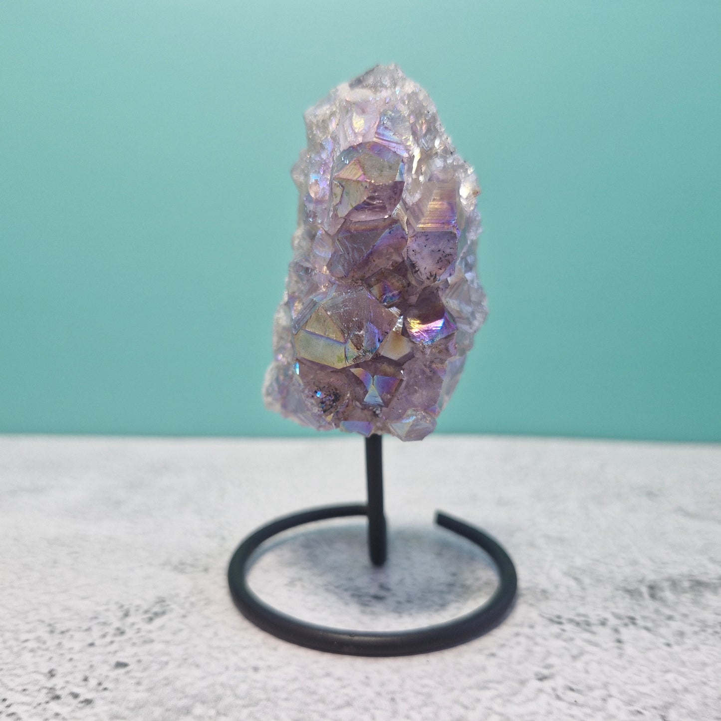 Small aura amethyst geode on stand