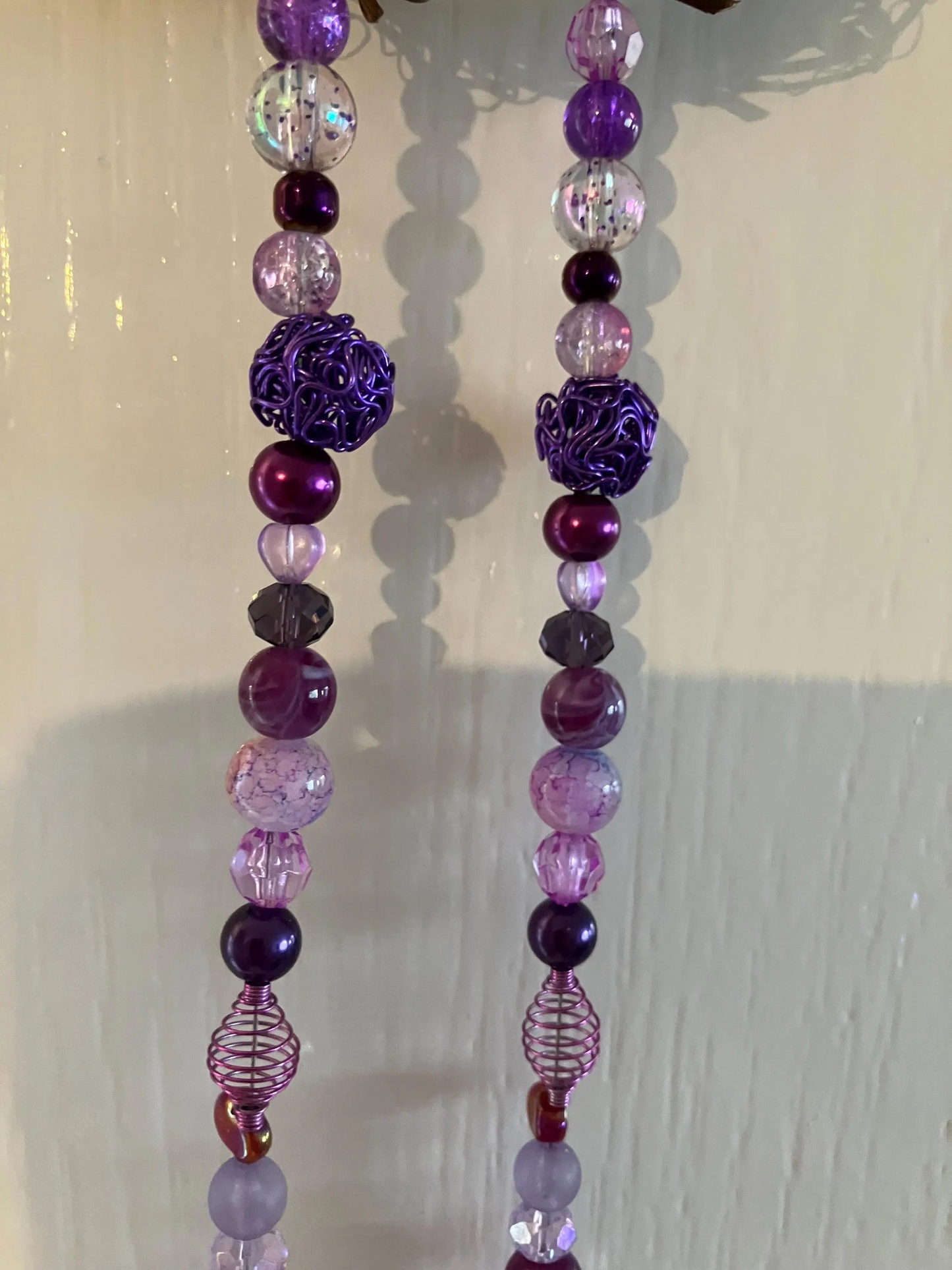 Beautiful handmade sun catchers hanging from a wicker hoop