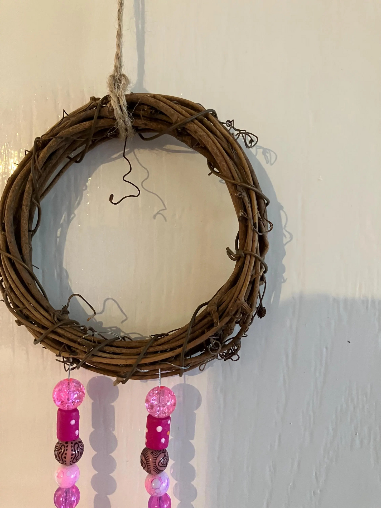 Beautiful handmade sun catchers hanging from a wicker hoop