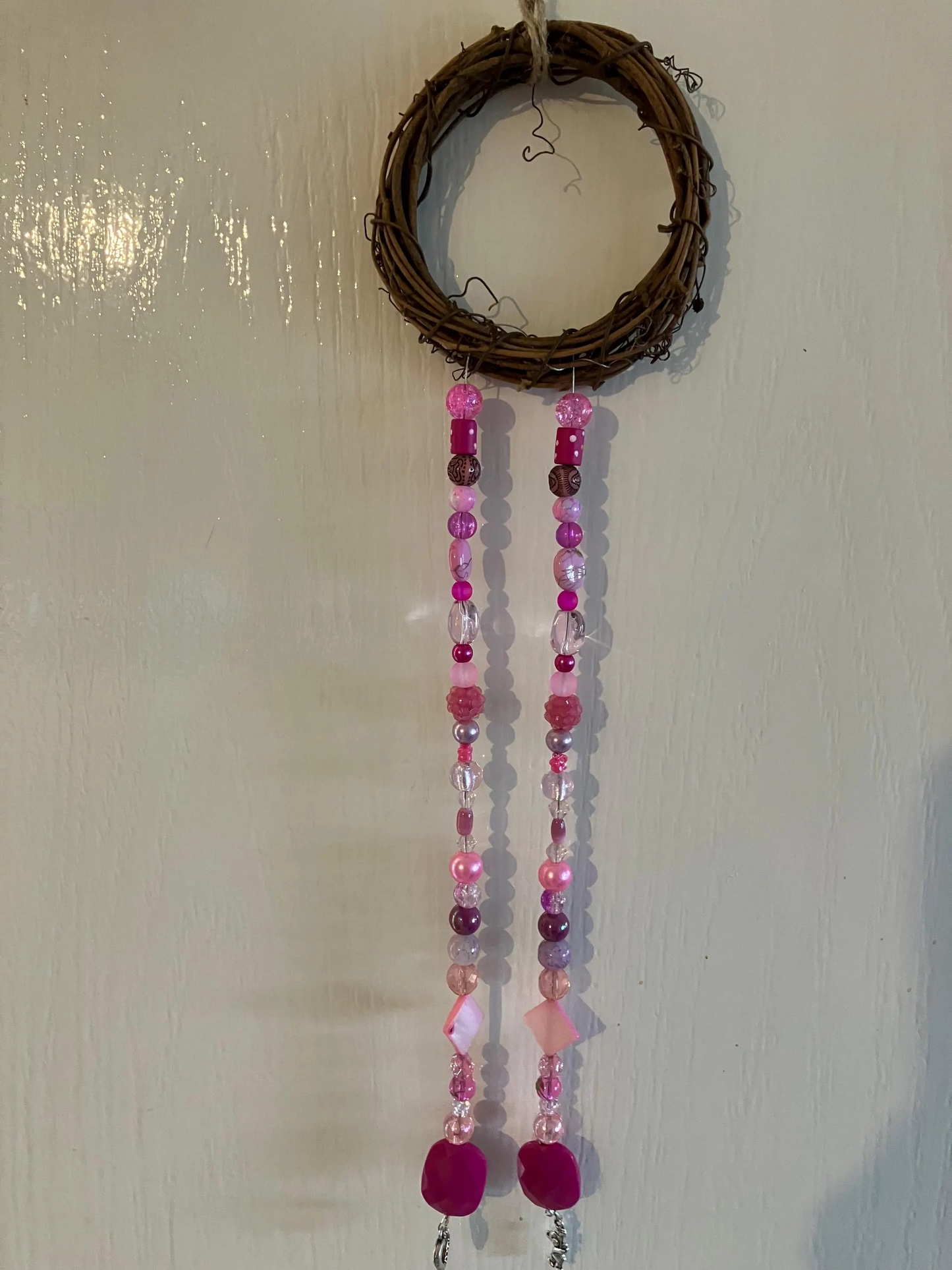 Beautiful handmade sun catchers hanging from a wicker hoop