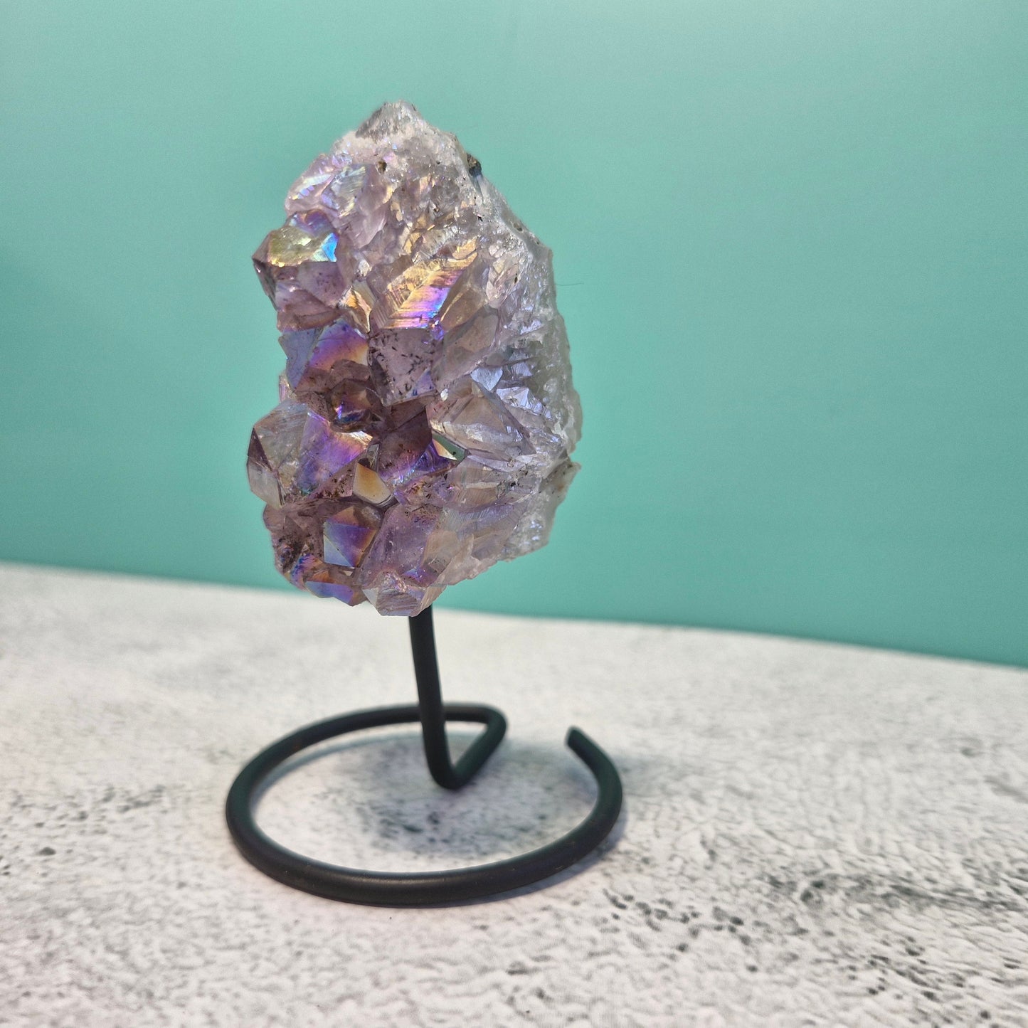 Small aura amethyst geode on stand