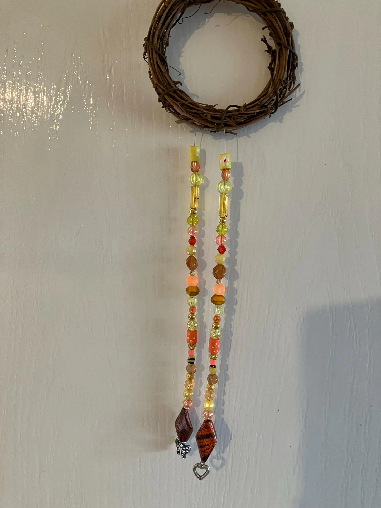 Beautiful handmade sun catchers hanging from a wicker hoop